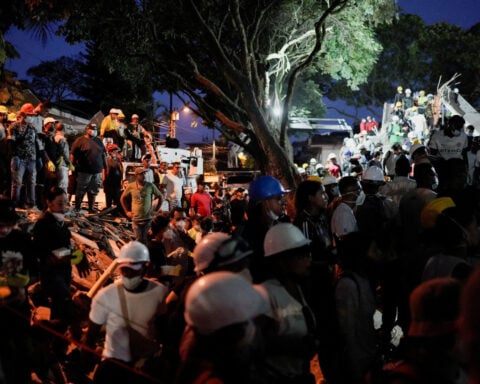 After a whisper saved baby and father from rubble, the search is on for mother in collapsed building in Colombia