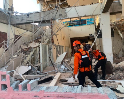 Rescuers dig through rubble and landslides after Indonesia quake kills 47
