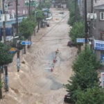 Heavy rains kill 1 in South Korea and flood major streets in Philippines