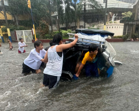 Heavy rains kill 1 in South Korea and flood major streets in Philippines