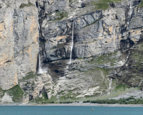 A looming rock collapse threatens a Swiss village as thawing permafrost destabilizes the Alps