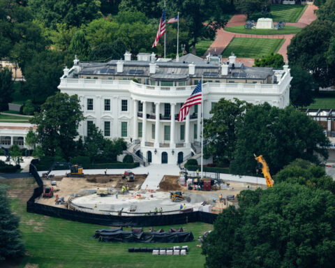 Trump the builder carves his legacy in stone as pressures mount
