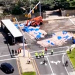 Truckload of squid spills into the street in Rhode Island, creating a smelly mess in the summer heat