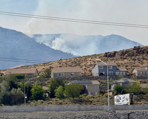Firefighters are trying to stop a fast-moving Nevada wildfire from spreading to homes in Reno