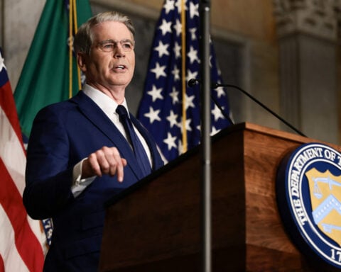 US threatens countries doing business with Iran, but holds off on penalties for now