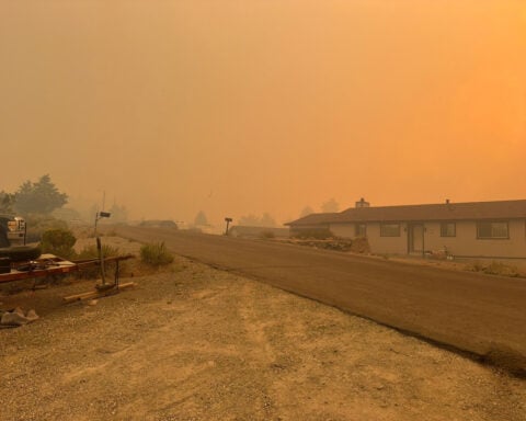 Firefighters make progress against a Nevada wildfire that's destroyed more than 30 homes