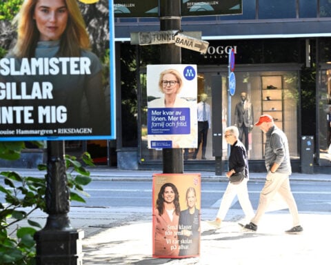 Sweden's ruling coalition trails in poll, but closes gap on centre-left opposition
