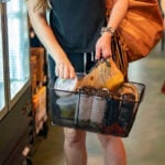 Consumers pulled back on spending in July in the face of continuing price pressures