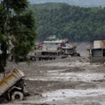 What triggered the catastrophic flood on the Nepal-Tibet border?