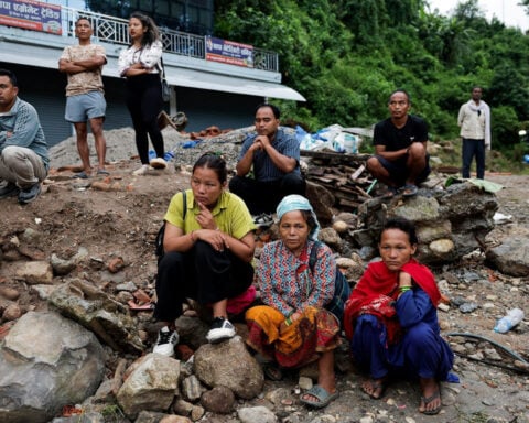 Around the world, people desperately search for news of missing loved ones after Nepal-China floods