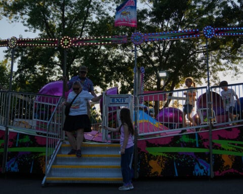 Spinning and dipping, Minnesota fairgoers delight in the classic Tilt-A-Whirl ride as it turns 100