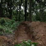 Nepal begins mass burials of unidentified flood victims as families seek missing