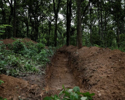 Nepal begins mass burials of unidentified flood victims as families seek missing