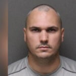 Officer charged with raping woman he escorted home held without bond