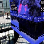 Shares skid in Asia as oil, yields stay high