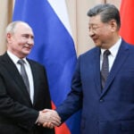 China's Xi tells Putin that foundations of ties will be stronger