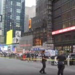 A woman brandishing two knives is shot by police in Times Square