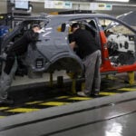 UK manufacturing PMI slips to five-month low but hiring strengthens