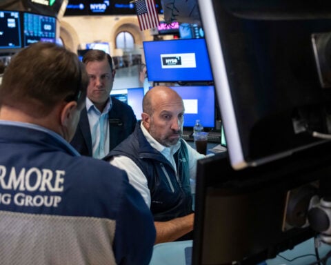 Stocks fall after a surprisingly strong jobs report raises prospects of an interest rate hike