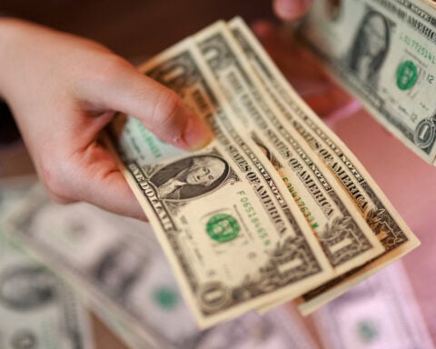 Dollar bounces on job gains, then pares ahead of CPI