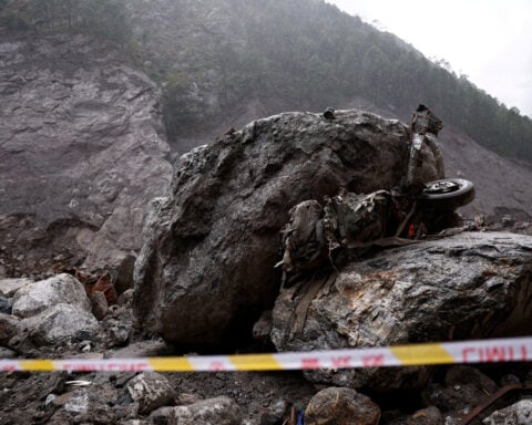 At flood-destroyed border, China teams scour ruins of once-busy port