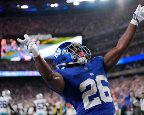 Giants' offense rolls over the Cowboys to give coach John Harbaugh a 28-20 win in his debut