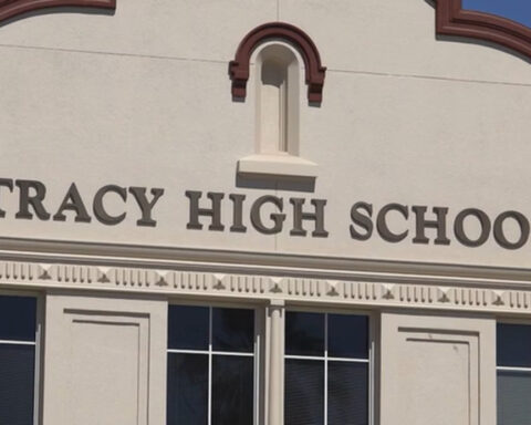 Coach arrested after phone found recording students in locker room, police say