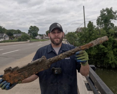 Man pulls World War II-era machine gun from river