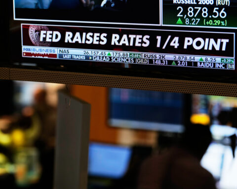 US stocks slip after the Fed hikes interest rates and hints more increases may be on the way