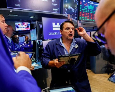 Wall St ends lower after Fed hikes interest rates, sees more tightening ahead