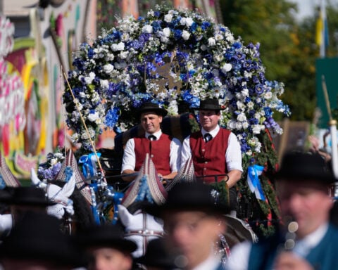Munich’s Oktoberfest roars to life as the mayor taps the first keg
