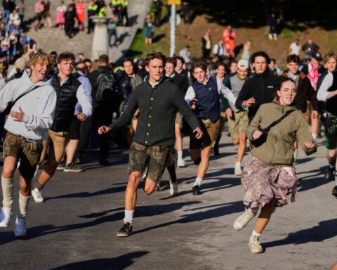 Munich’s Oktoberfest roars to life as the mayor taps the first keg