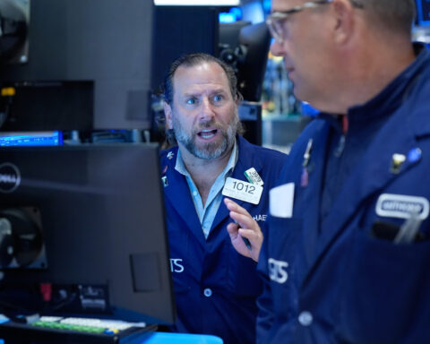 Wall Street holds near its record after Brent oil falls below $100 per barrel