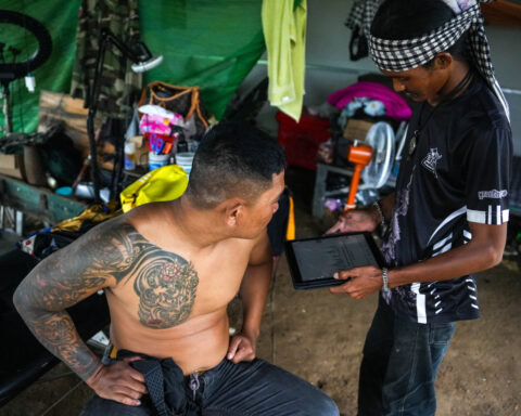 In Cambodia's 'Waiting Village', tattooist mourns trade lost to war