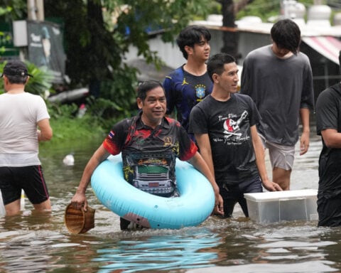 Rain eases in Bangkok but persistent flooding forces thousands to leave home