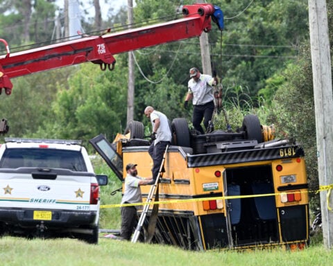 2 people killed, including a student, after Florida school bus rolls over in crash