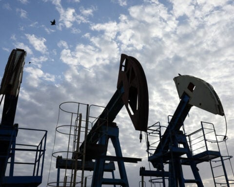 Oil prices settle higher as more production shut ahead of hurricane