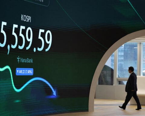 Global stocks edge lower as AI and rate fears hit tech