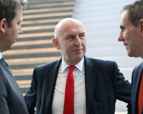 UK's Healey says banks are key to economy but keeps tax options open