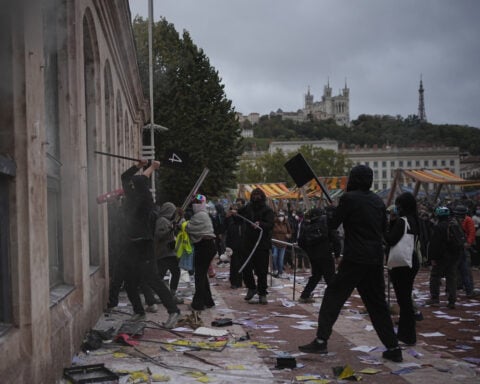 Clashes, fires and looting break out as protesters rally across France, joining students