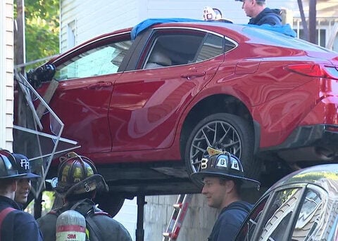 Car left hanging after crashing into house in Jamaica Plain: "It looked like a movie scene"