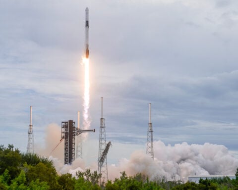 Elon Musk's SpaceX reports a profit and he hints at a possible merger with Tesla