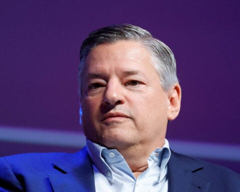 Netflix issues weak fourth-quarter forecast, shares drop 