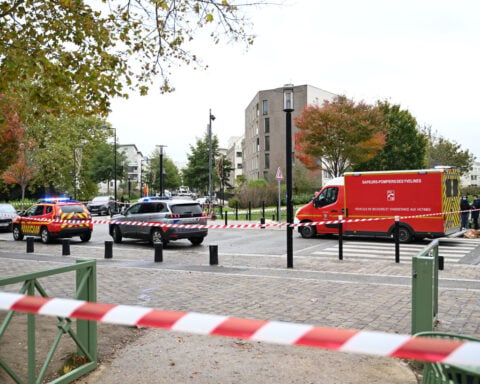A shooting in the Paris suburbs kills 1 and wounds five in a suspected racist attack