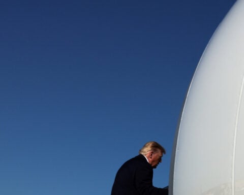 Trump, ignoring polls, predicts economy to help Republicans in midterms